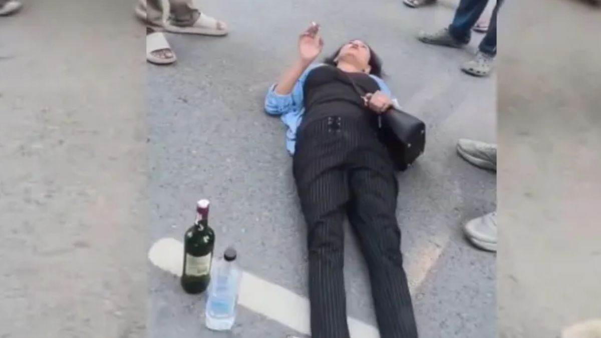 नोएडा में नशे में धुत युवती का हंगामा, हाथ में सिगरेट और शराब की बोतल रख बीच सड़क पर लेटी